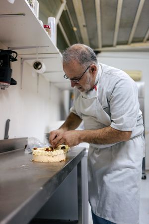Pastry chef decorating a cake