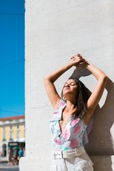 Dreamy stylish woman standing on city street