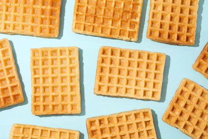 Flat lay composition with belgian waffles on color background