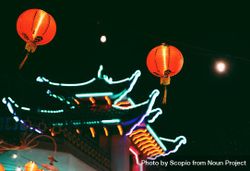 Red lit lanterns near pagoda under night sky bDJWJ5