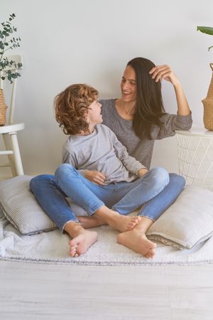 Cheerful mother with son on blanket