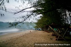 Foggy beach in Indonesia with people walking in distance 4dwor5