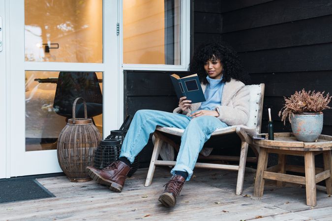 Black woman reading book outside