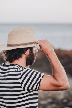 Bearded male in hat on deserted road