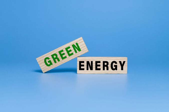 green energy words text on wooden blocks isolated on blue background
