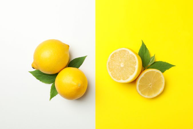 Fresh lemons on two tone background, top view. Ripe fruit