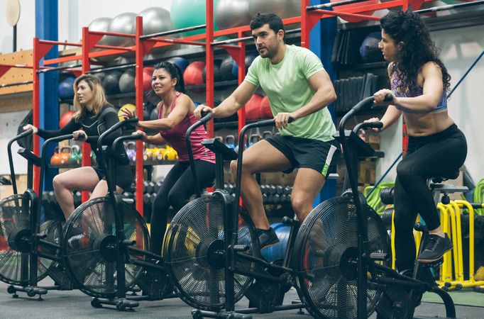 Athletes doing air bike indoor