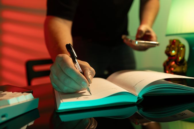 Man Writing in Journal for Business and Learning