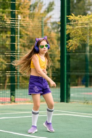 Girl dancing on sports ground