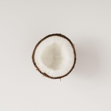 Coconut half on light background