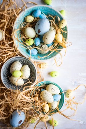 Bowls of Easter eggs surrounded with hay