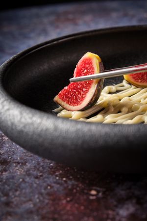 Fresh sliced fig in bowl at restaurant