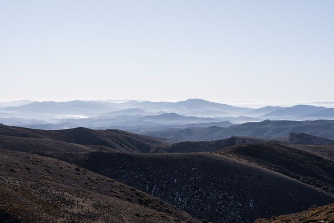 A landscape mountainous view with a lot of layers and deep of field and fog on the top