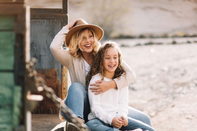 Mother hugging girl in truck body