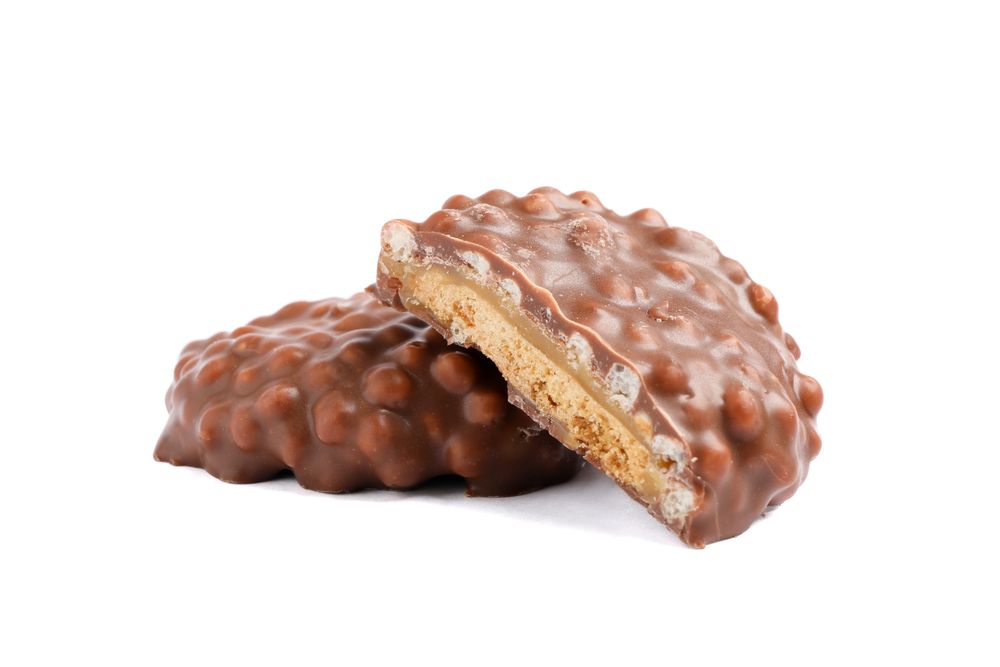 Chocolate cookies with caramel filling isolated on plain background