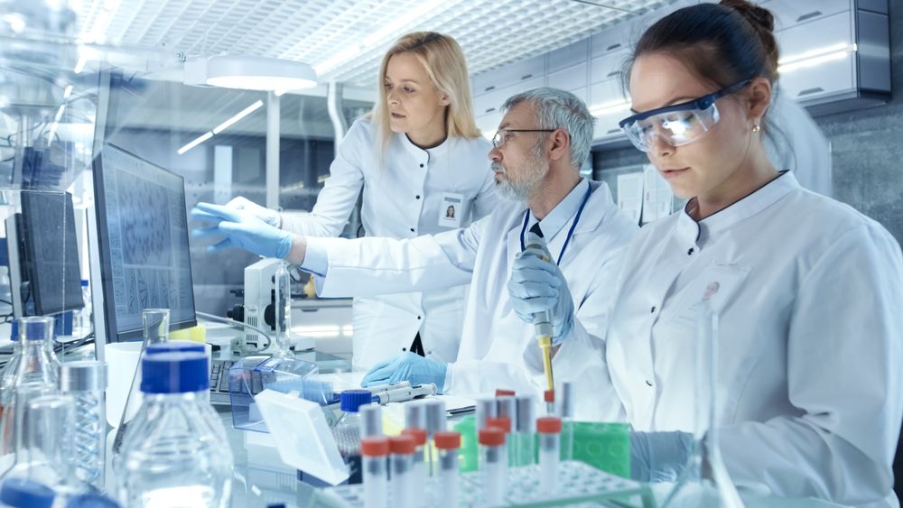 Team of Research Scientists Working With Personal Computer, Analysing Test Trial New Generation Drug Data.