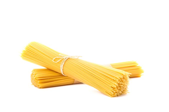 Pasta isolated on bright background. Uncooked whole wheat pasta