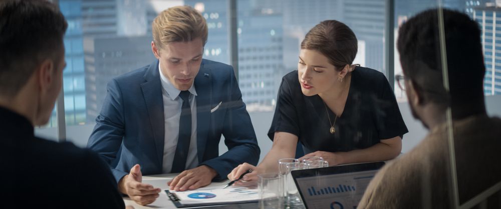 Multi-Ethnic Skyscraper Office Conference Room Meeting: Diverse Team of Executives Talk