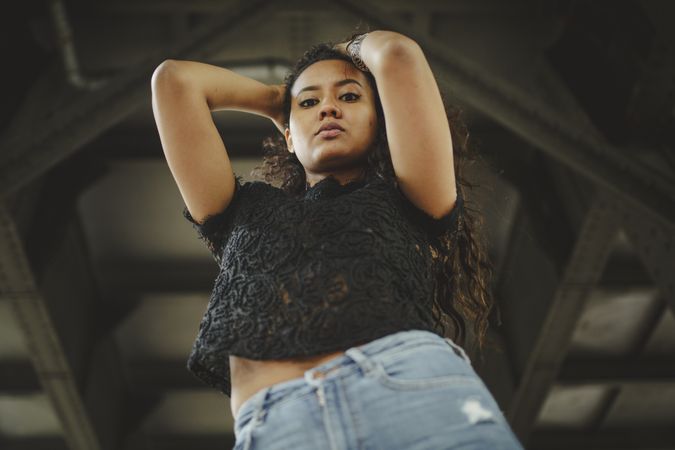 Cheerful hispanic model holding hair