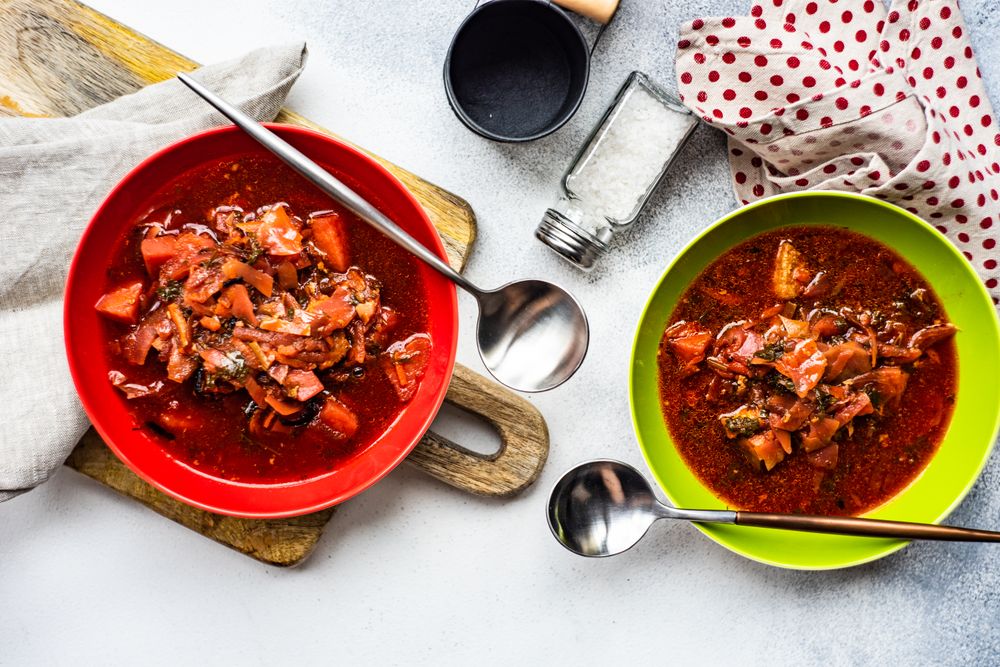 Looking down at two bowls of traditional Ukrainian beetroot soup borscht
