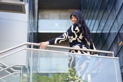 Sensual dancer turning to look down from urban viewpoint