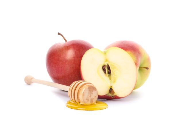 Apples and dipper with honey isolated on neutral background