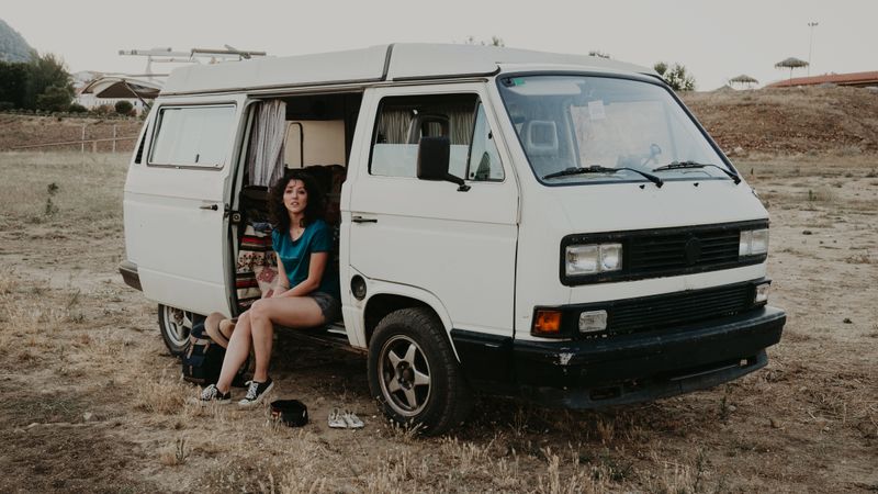Smiling woman sitting in retro car