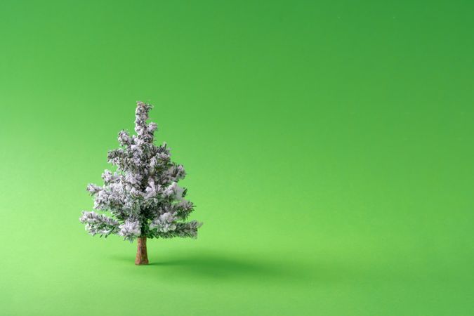 Snowy wooden Christmas tree decoration with green background