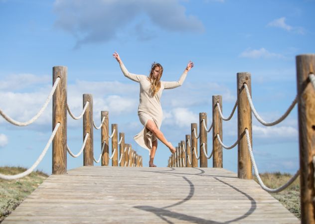 Young woman posing on footbridge
