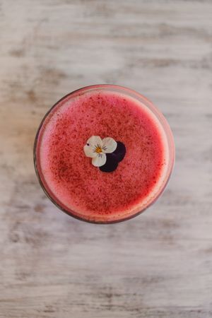 Delicious pink smoothie with frothy in glass