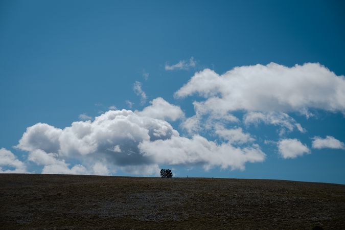 Landscape with hill and moon in blue sky