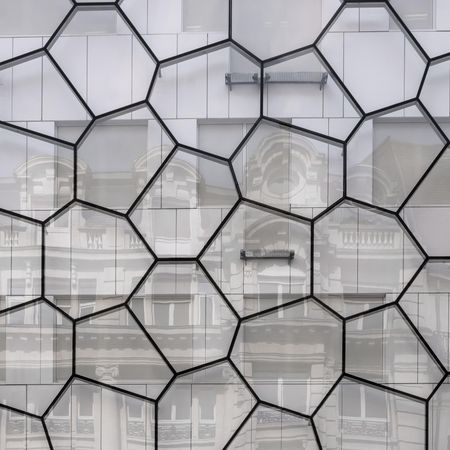Random polygonal pattern on glass reflecting and old architectural building