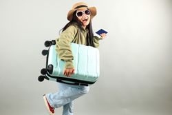 Young Traveler Asian Woman with Luggage, Ticket, and Passport