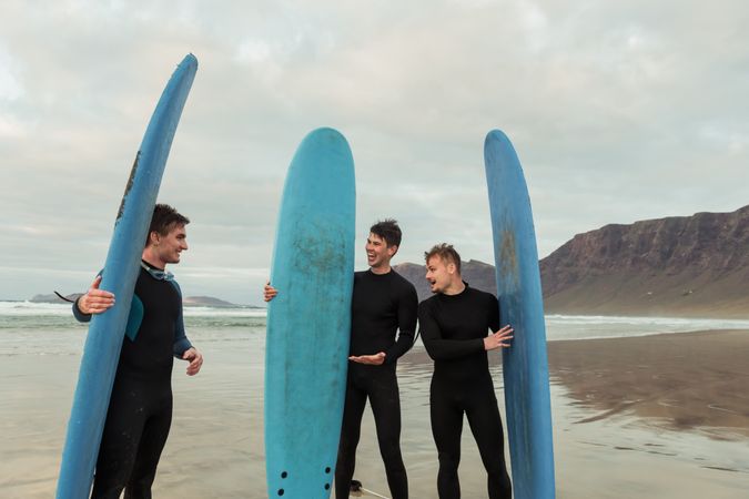 Excited men with surfboards