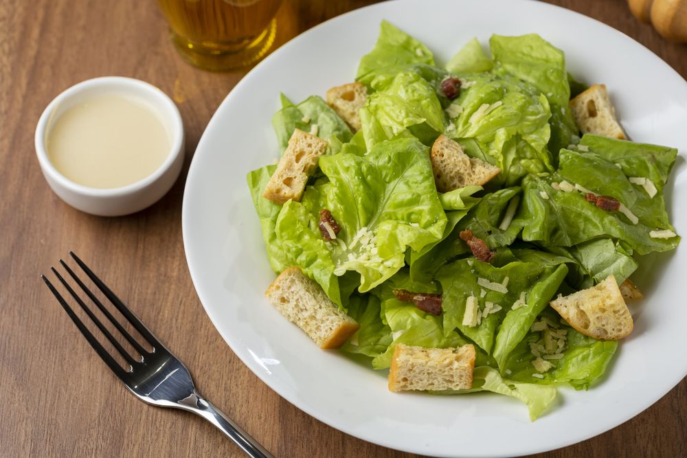 Caesar salad with croutons and bacon.