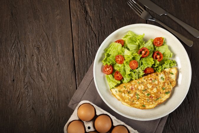 Omelet with cheese and lettuce and tomato salad.