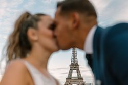 Happy newlyweds in wedding clothing kissing