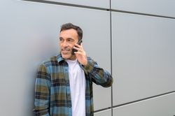 Smiling man talking on smartphone