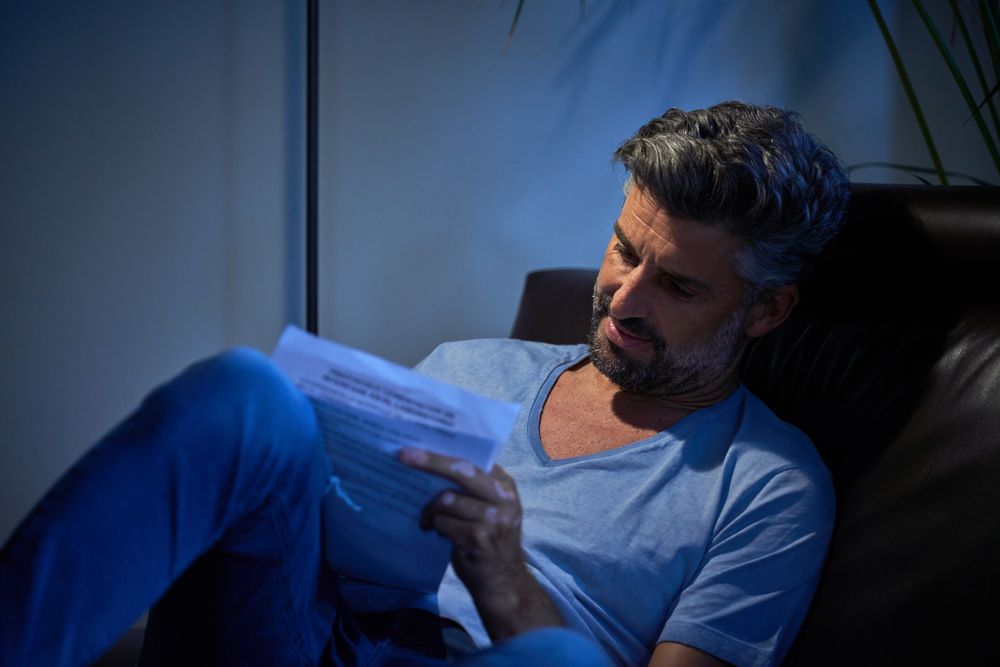 Concentrated employee writing notes in dark room
