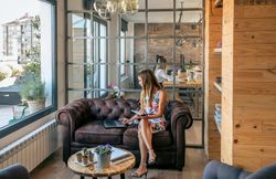Woman working with laptop sitting on the sofa