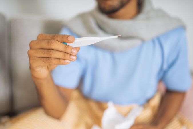 Man looking at the digital thermometer