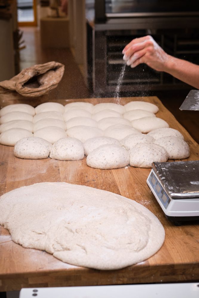 Photo detail of a baker's hands working the bread dough