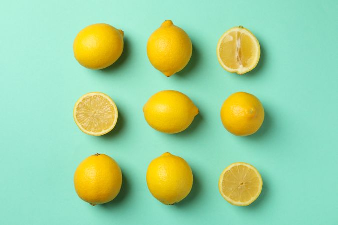 Flat lay with lemons on mint background. Fresh fruit