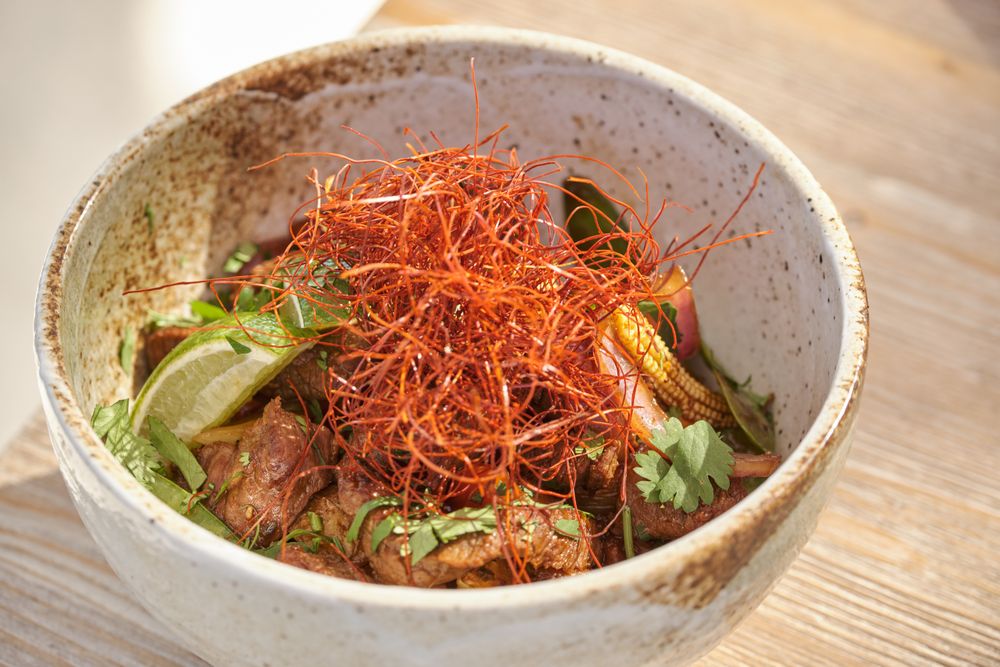 Bowl of chicken and lime with chili threads