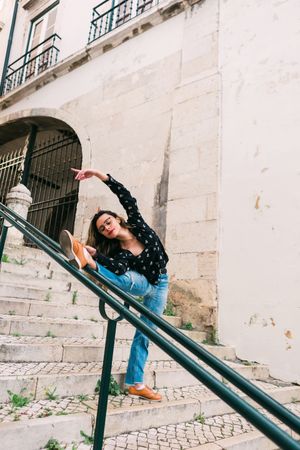 Casual woman dancing on old city street