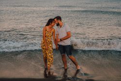 Loving couple embracing happily on sandy beach