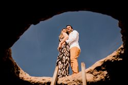 Excited lovers embracing on rock