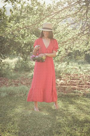 Adult lady with basket in countryside