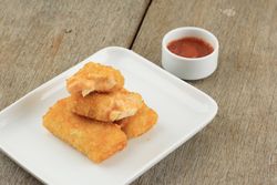 Plate of risol mayo keju, fried thin crepes rolled with egg and mayonnaise filling