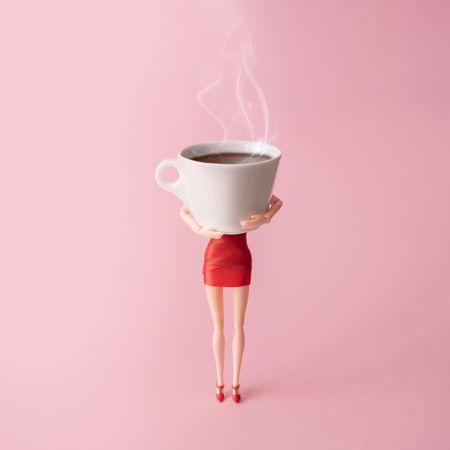 Barbie like doll in red dress holding a coffee cup with pink background